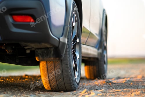 Preview: Close up of blue off road car wheel on gravel road.