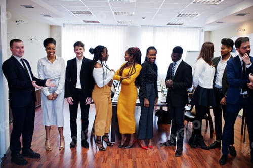 Preview: Multiracial young creative people in modern office