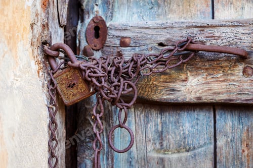 Preview: Rusty door lock and chain on an old door