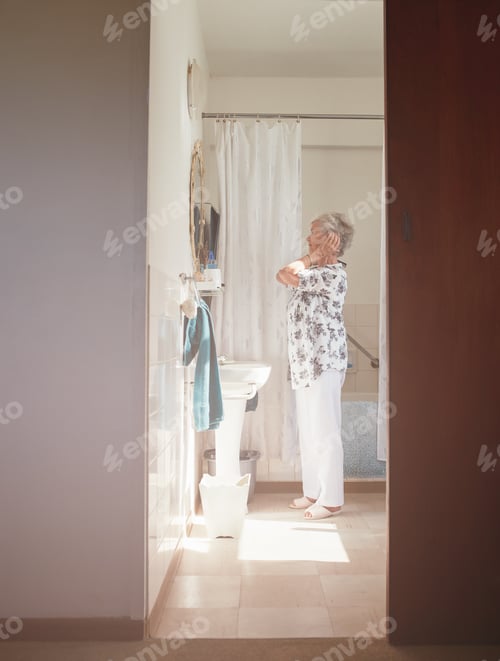 Preview: Senior female getting ready in bathroom