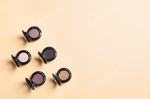 Preview: Flat lay composition with different eye shadows on color background. Space for text