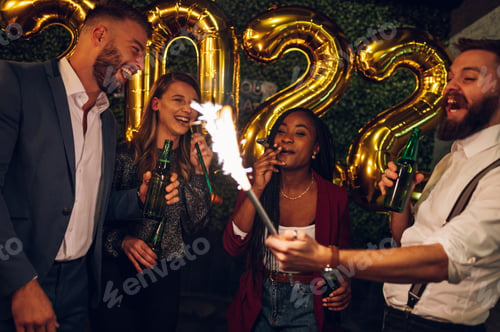 Preview: Happy group of friends celebrate New Year's Eve in a club
