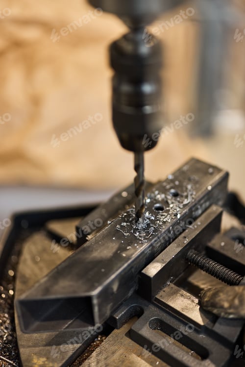 Preview: Close-Up of Metal Drilling Process in Industrial Workshop