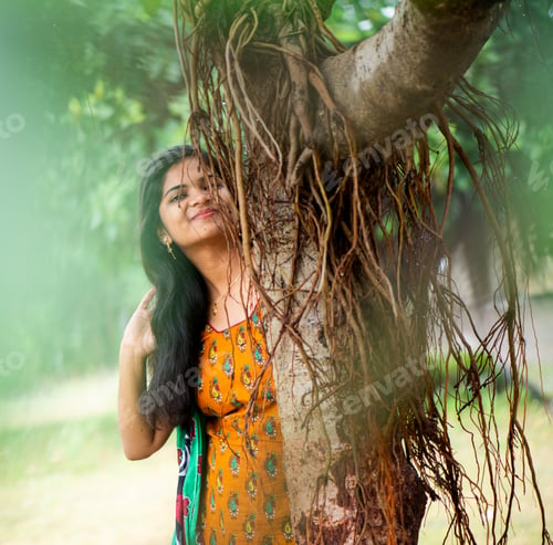 Preview: Happy woman near banyan tree