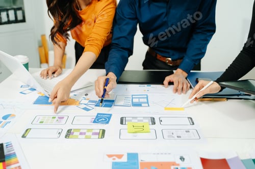 Preview: Creative team planning UI UX mobile app interface with wireframes and analytics, collaborating