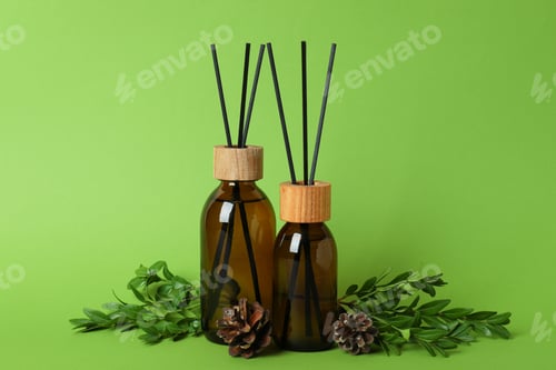 Preview: Aroma scent diffusers, cones and leaves on green background