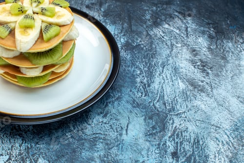 Preview: Above view of fluffy American-style pancakes made with natural yogurt and stacked with layers of
