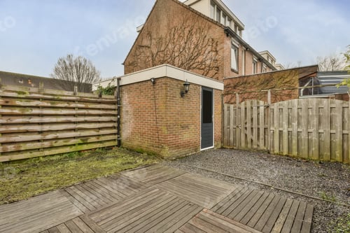 Preview: A backyard with a lawn, a plant bed