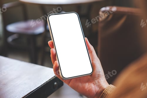 Preview: Mockup image of a woman holding mobile phone with blank desktop screen in cafe