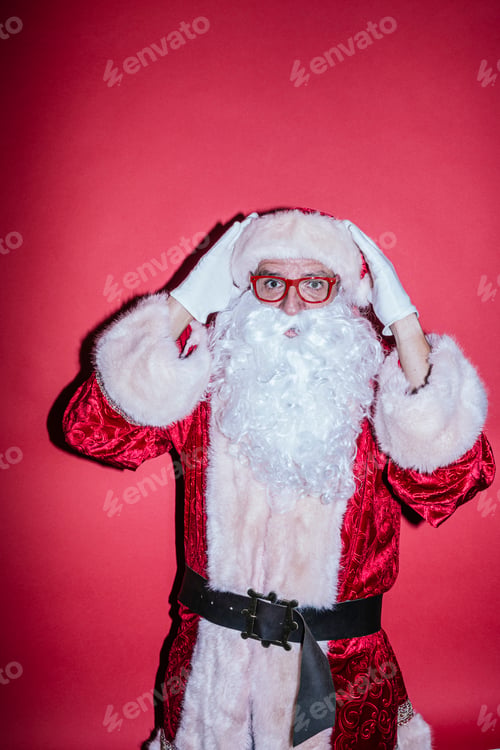 Preview: Man dressed as Santa Claus gesturing with funny glasses