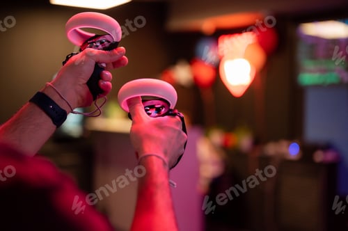 Preview: vr game and virtual reality. man gamer with joysticks playing on shooting simulation video game