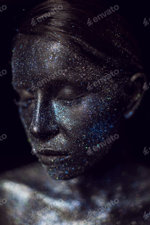 Preview: fashionable portrait of a woman in black paint with sequins on her face. closed eyes