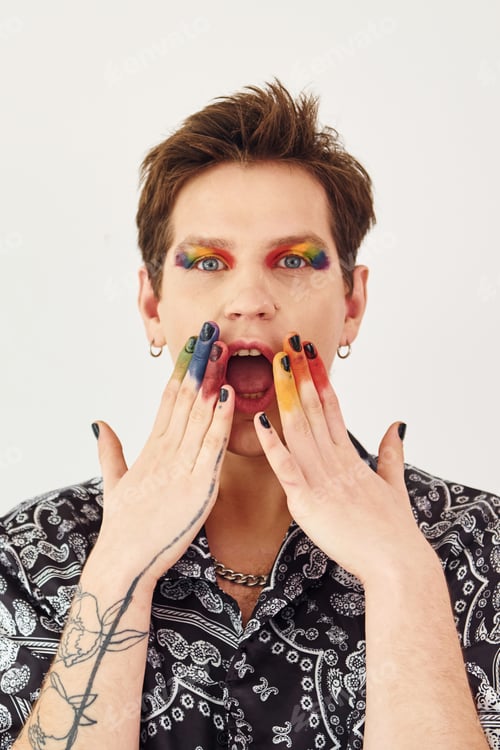 Preview: Young gay man is standing in the studio and posing for a camera