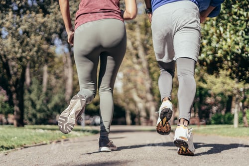 Preview: Rear close up view of two runner legs in park