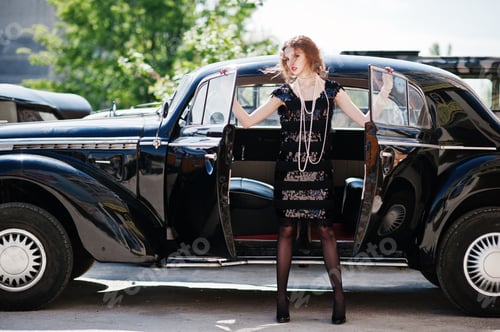 Preview: Girl model with bright makeup in retro style in vintage car