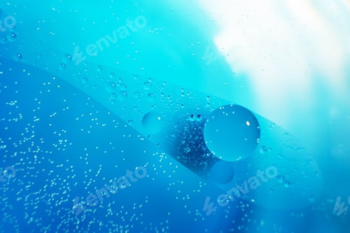 Preview: Oil bubbles close up. circles of water macro. abstract light blue background
