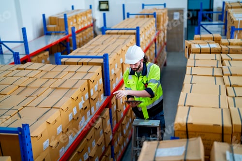 Preview: Upper view warehouse worker man stand on stair and hold tablet to check product on shelves
