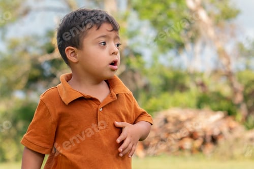 Preview: A curious child with Down syndrome lost in thought in a rustic countryside setting