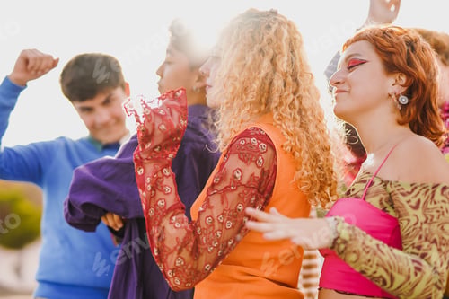 Preview: Happy young people having fun dancing together during summer music concert