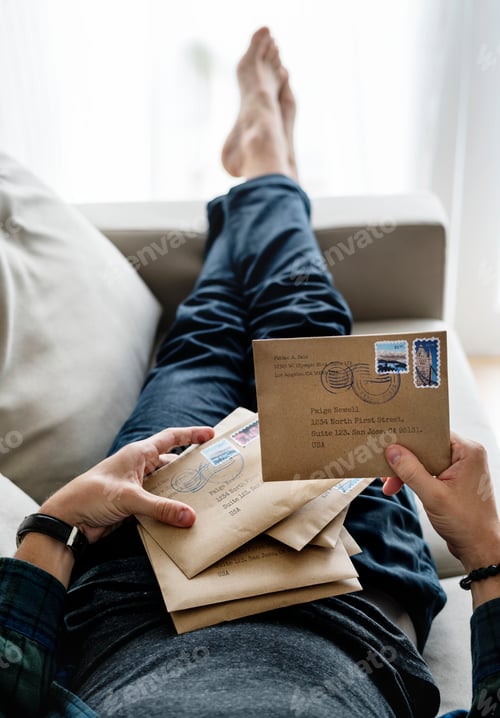 Preview: Aerial view of a man sorting an envelope