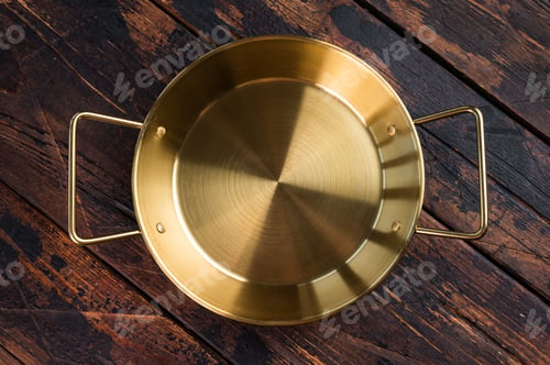 Preview: Empty shiny metal saute pan on dark wooden background, professional kitchen utensil