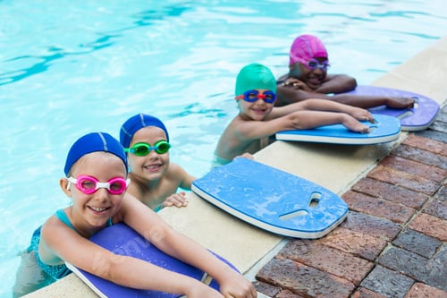Preview: Little swimmers with kickboards at poolside