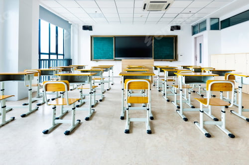Preview: Empty Classroom Interior with Desks and Chalkboard