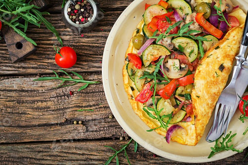Preview: Omelet with tomatoes, zucchini and mushrooms. Omelette breakfast. Healthy food. Top view. Flat lay