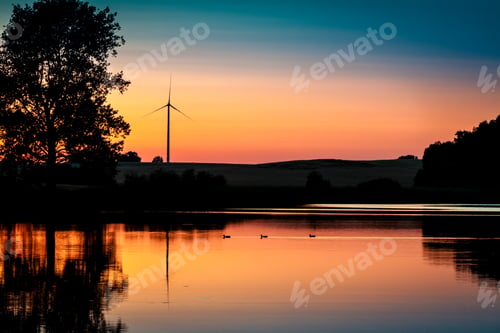 Preview: Wind Turbine and sunset at lake in summer