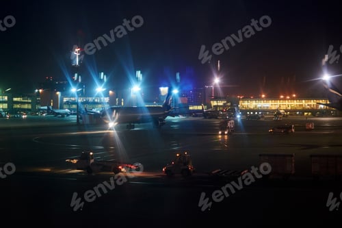 Preview: planes stand in an empty airport at night. airport lights