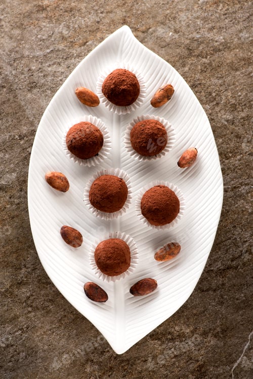 Preview: Chocolate candy truffle and cocoa beans. Art plate