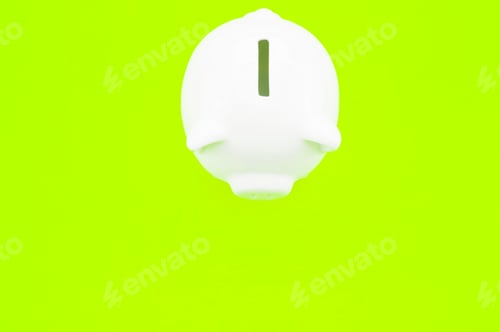 Preview: Closeup shot of a piggy bank on a green surface - investments and savings concept