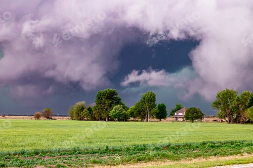 Preview: Low storm clouds move over a homestead in Nebraska