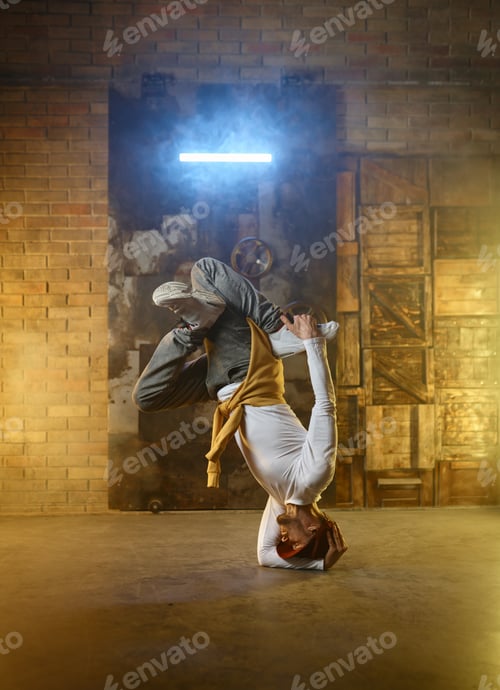 Preview: Handsome young man developing freeze over dance studio background
