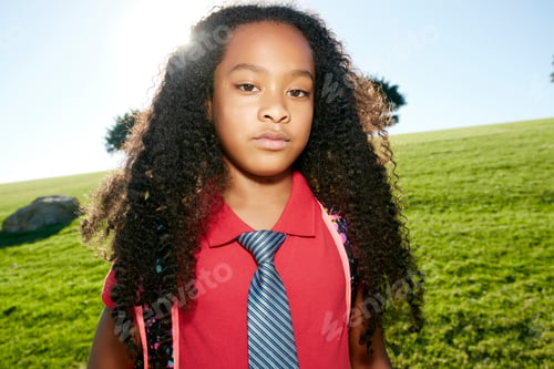 Preview: Young mixed race girl in pink shirt and formal tie, wearing a backpack