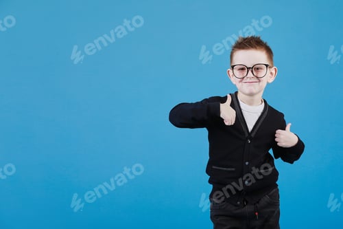 Preview: Young Boy Giving Two Thumbs Up on Blue
