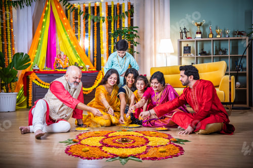 Preview: Indian family bonding over creating rangoli during Diwali or Ganesh festival celebration