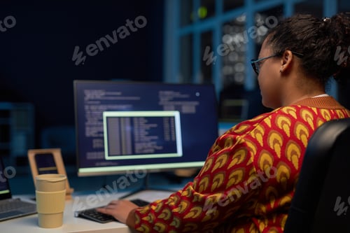 Preview: Female programmer working with computer codes