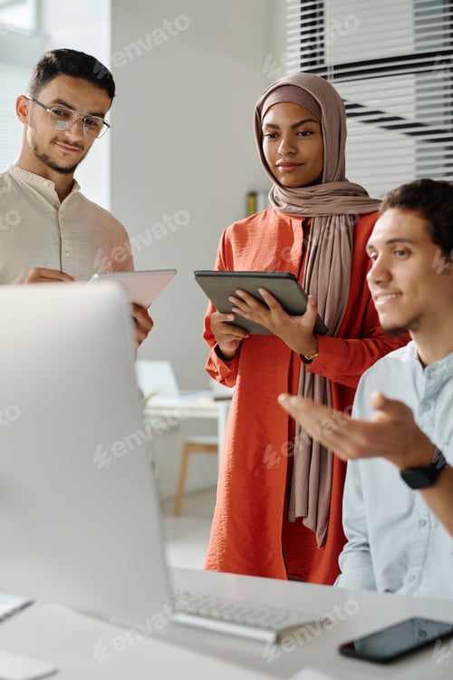 Preview: Two young Muslim brokers with tablets