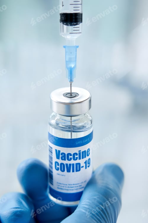 Preview: Male doctor or scientist hand holding syringe taking covid 19 vaccine from vial.