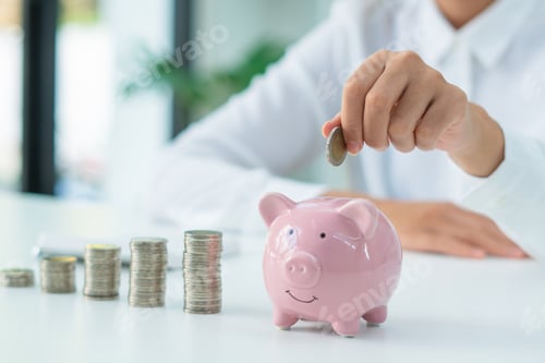 Preview: businessman holding coins putting in piggy bank. concept saving money for finance accounting