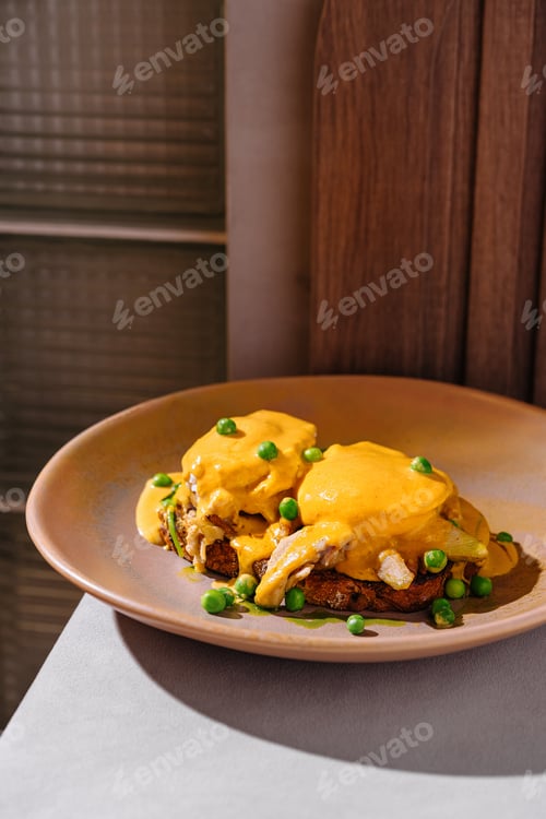 Preview: Delicious poached benedict eggs with hollandaise sauce served for brunch
