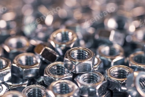 Preview: Metal chrome nuts in a chaotic order industrial background
