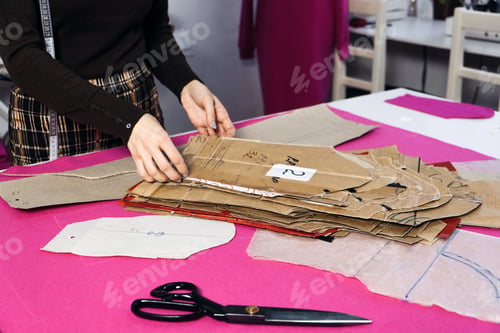 Preview: Sewing sustainable fashion industry. Seamstress working with clothing and sewing pattern on table