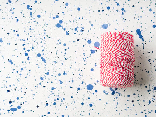 Preview: Red twine string roll on white background