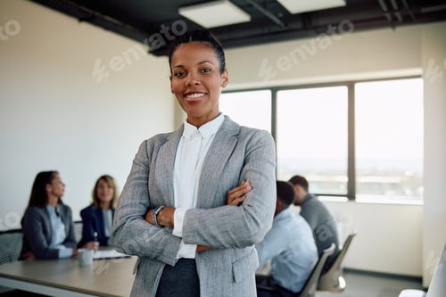 Preview: Confident black businesswoman with arms crossed in the office looking at camera.