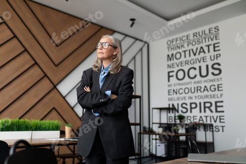 Preview: woman company owner businesswoman stands in the middle of the office and looks thoughtfully out the