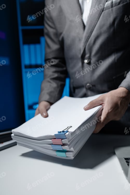 Preview: An employee held a large pile of documents in his hand, Large piles of work documents on desks are b
