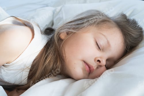 Preview: Little girl sleeps on pillow in bed with closed eyes. Evening late going to bed by mom. Bedtime