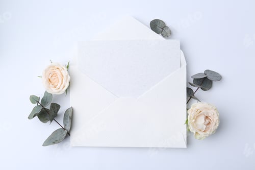 Preview: Blank greeting card in envelope, eucalyptus leaves and roses on white background, top view